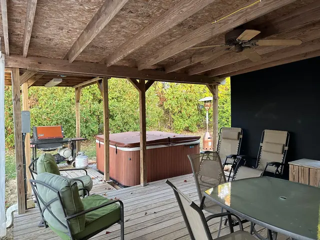 Hot tub on patio with propane grill